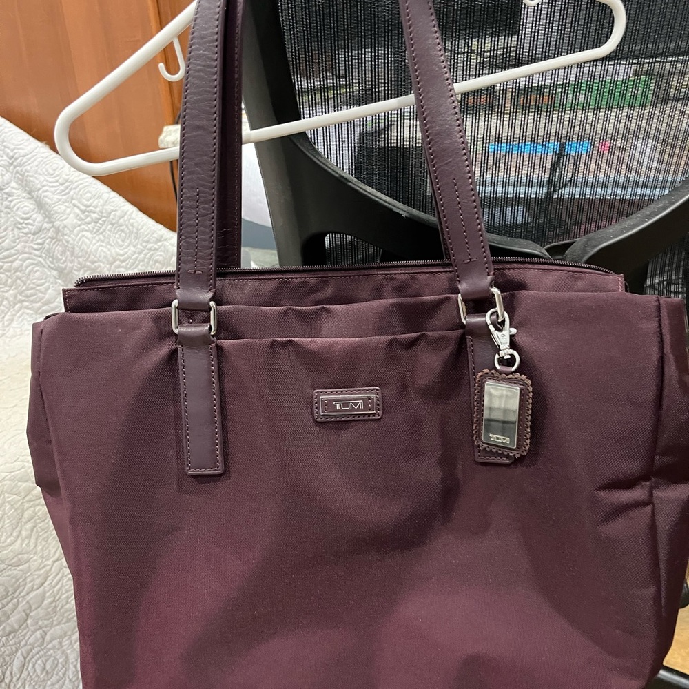Brand new Tumi travel bag. Leather handles and tag. 16x12” high! Never used